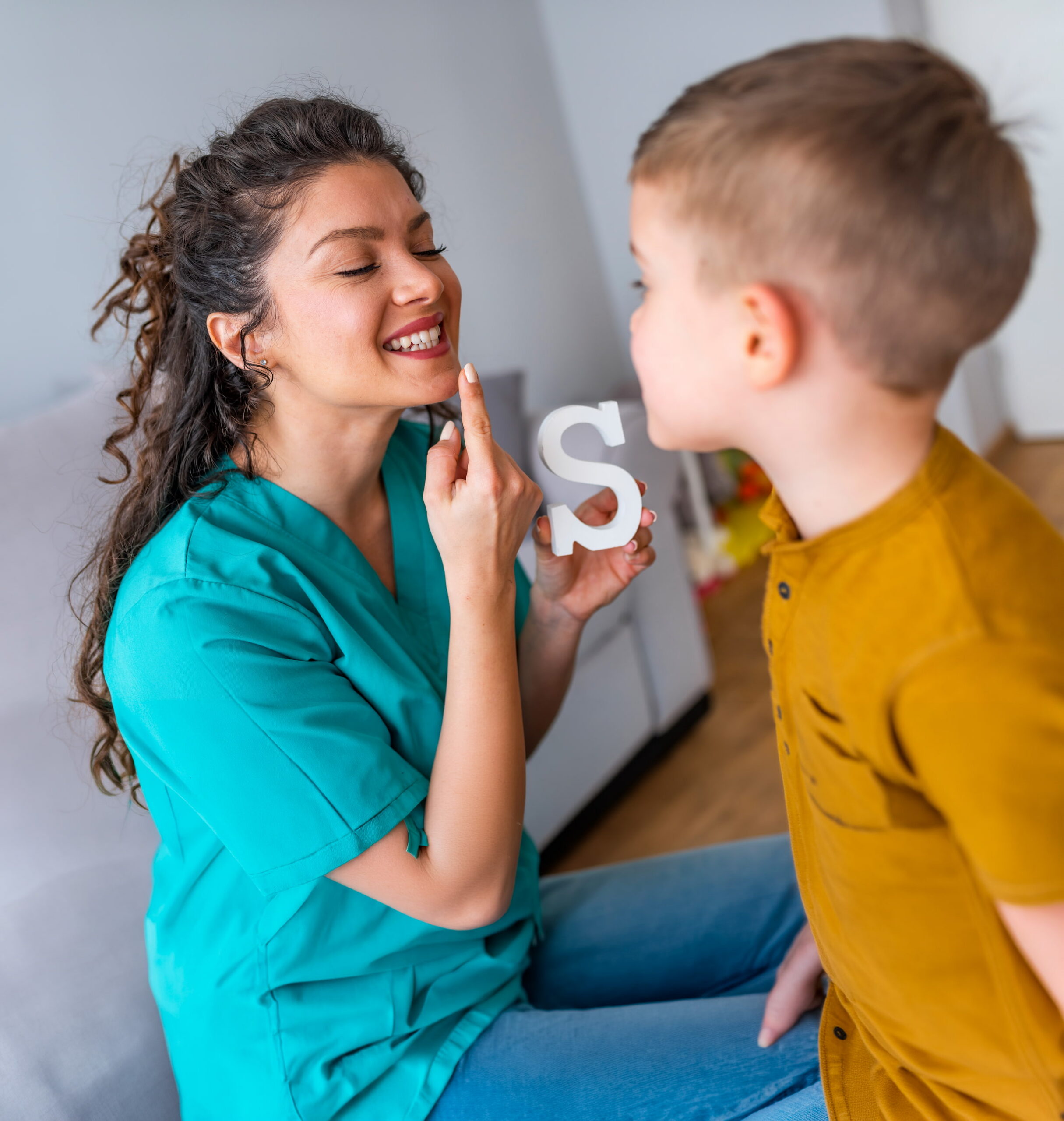 Cute little boy at speech therapist office. Shot of a speech therapist during a session with a little boy. Cute little boy at speech therapist office