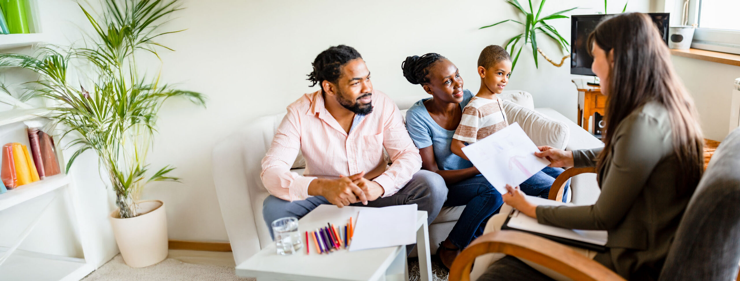A family and a therapist talking about a child's drawing