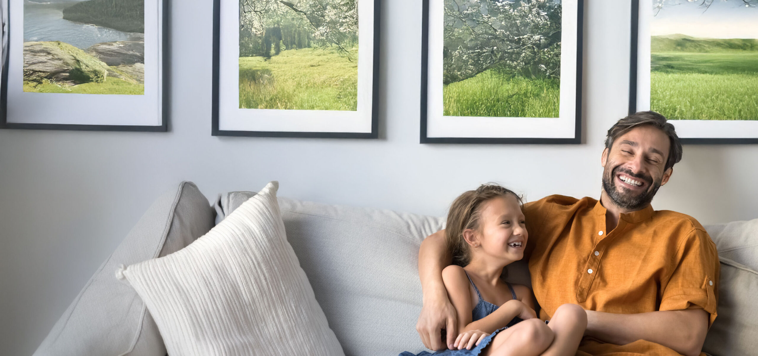 Middle-aged father laughing, tickling his little 6s adorable daughter, loving family sitting on comfortable sofa, giggling while joking, having fun or fooling enjoy carefree pastime on weekend at home